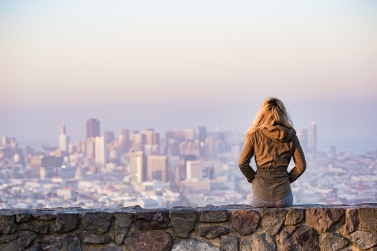 woman is looking at a big city